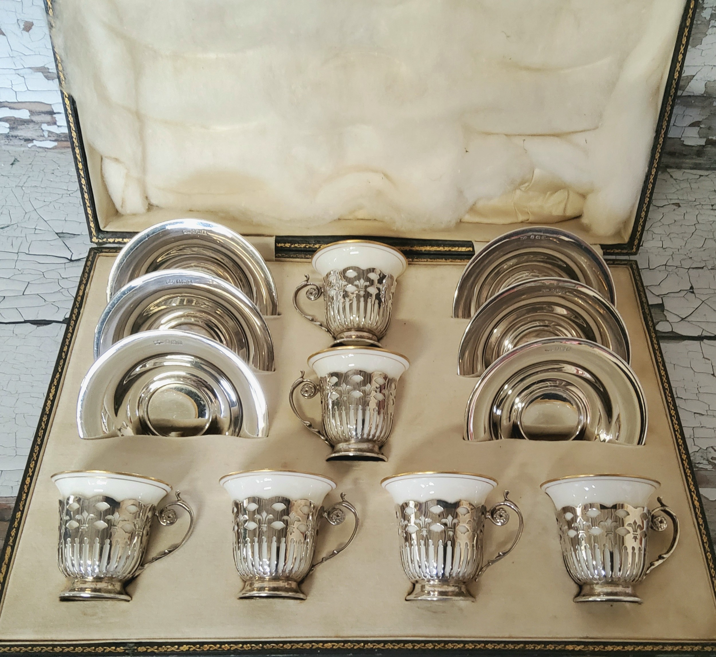 An Art Deco Set Of Six Silver Coffee Cup Holders & Silver Saucers