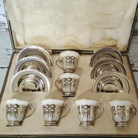 An Art Deco Set Of Six Silver Coffee Cup Holders & Silver Saucers